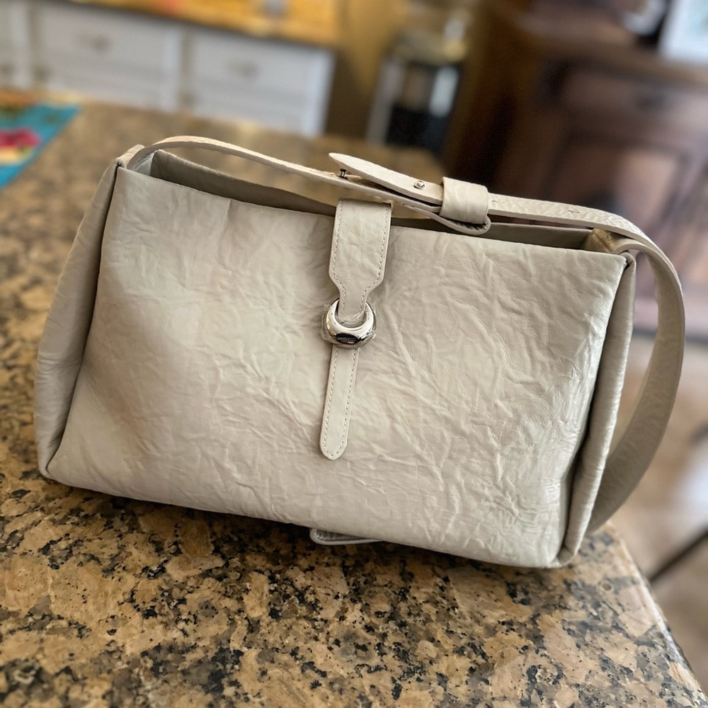 NWOT La Festin cowhide leather purse in ivory color with silver toned hardware